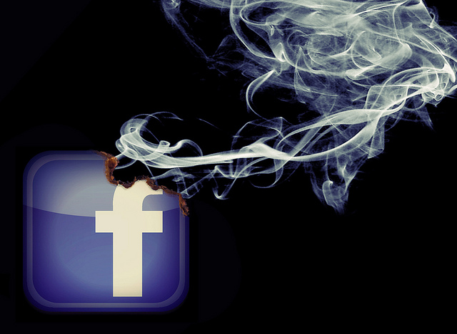 Facebook logo burning away slowly